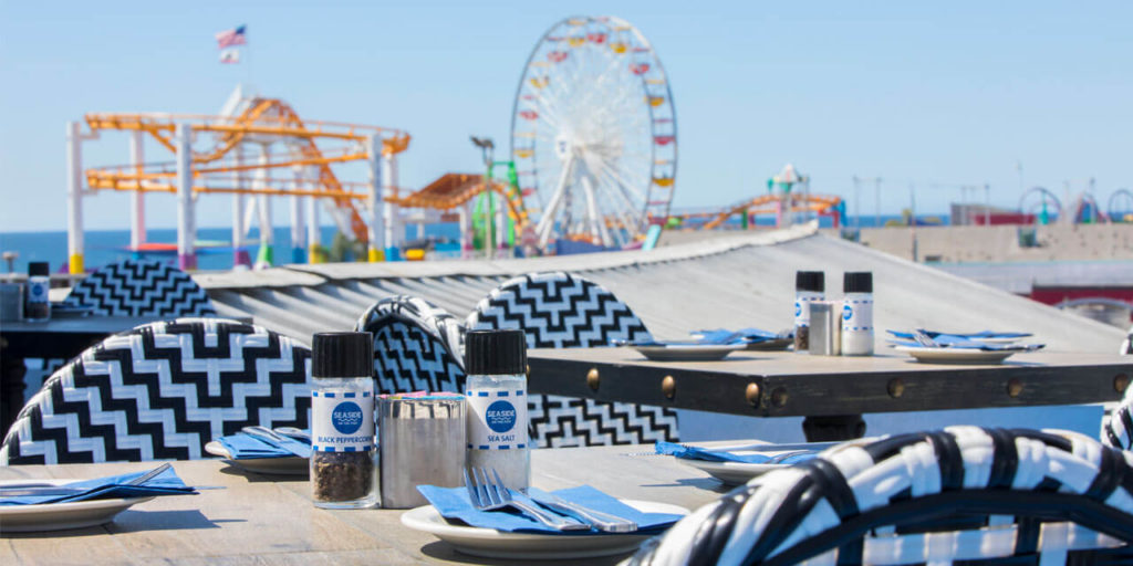 Seaside on the Pier Rooftop Table with Roller Coaster and Ferris Wheel in the background
