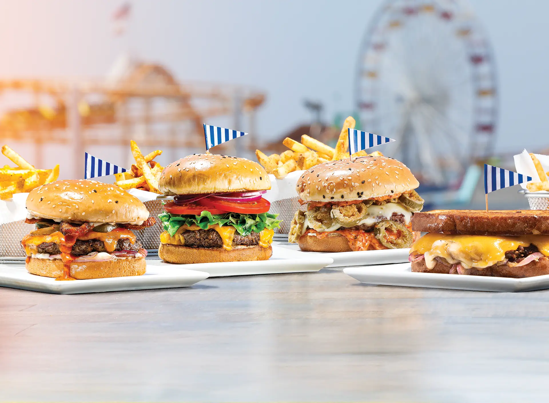 Burgers, pizza, and lobster roll with drinks