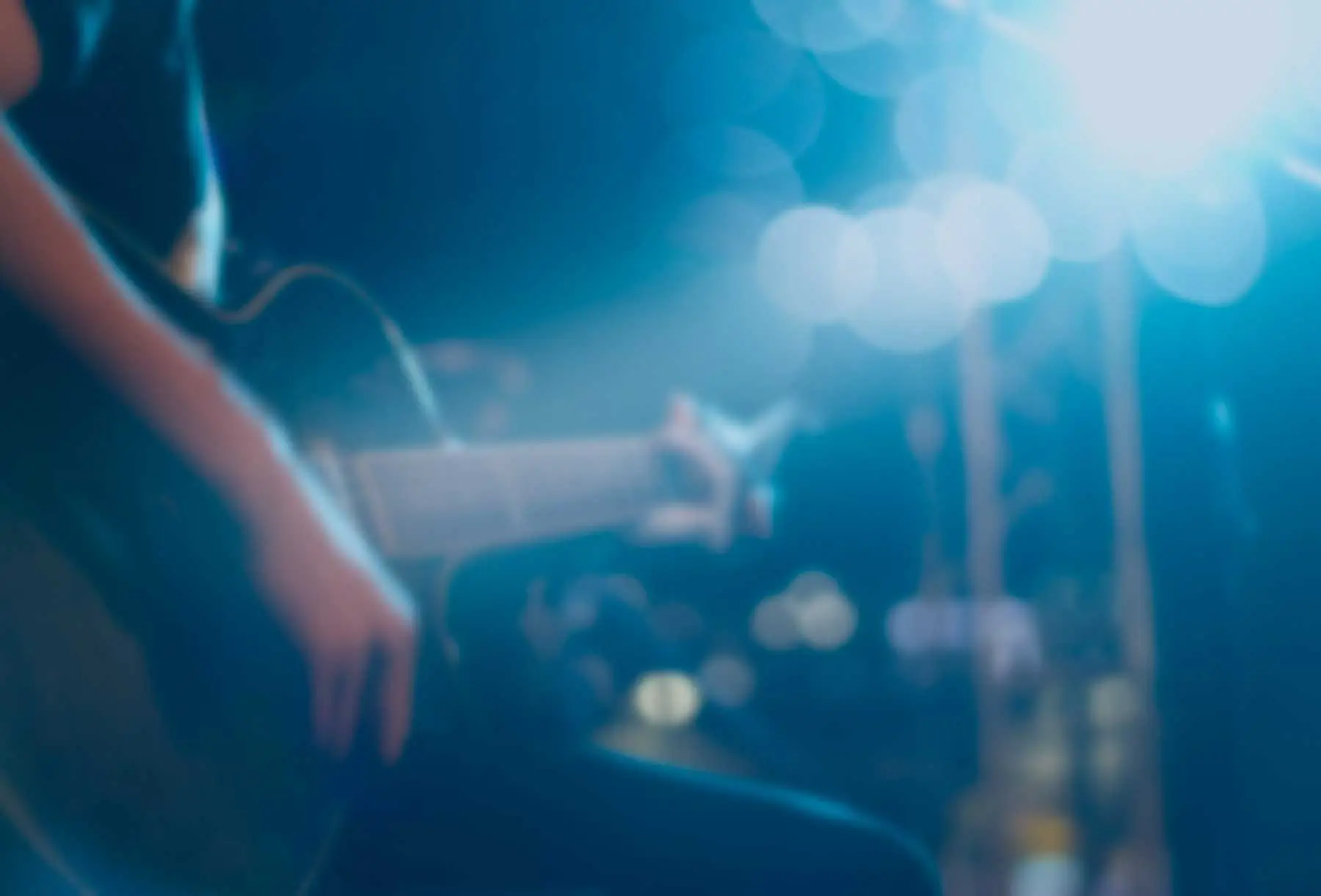 A man playing live music on a guitar